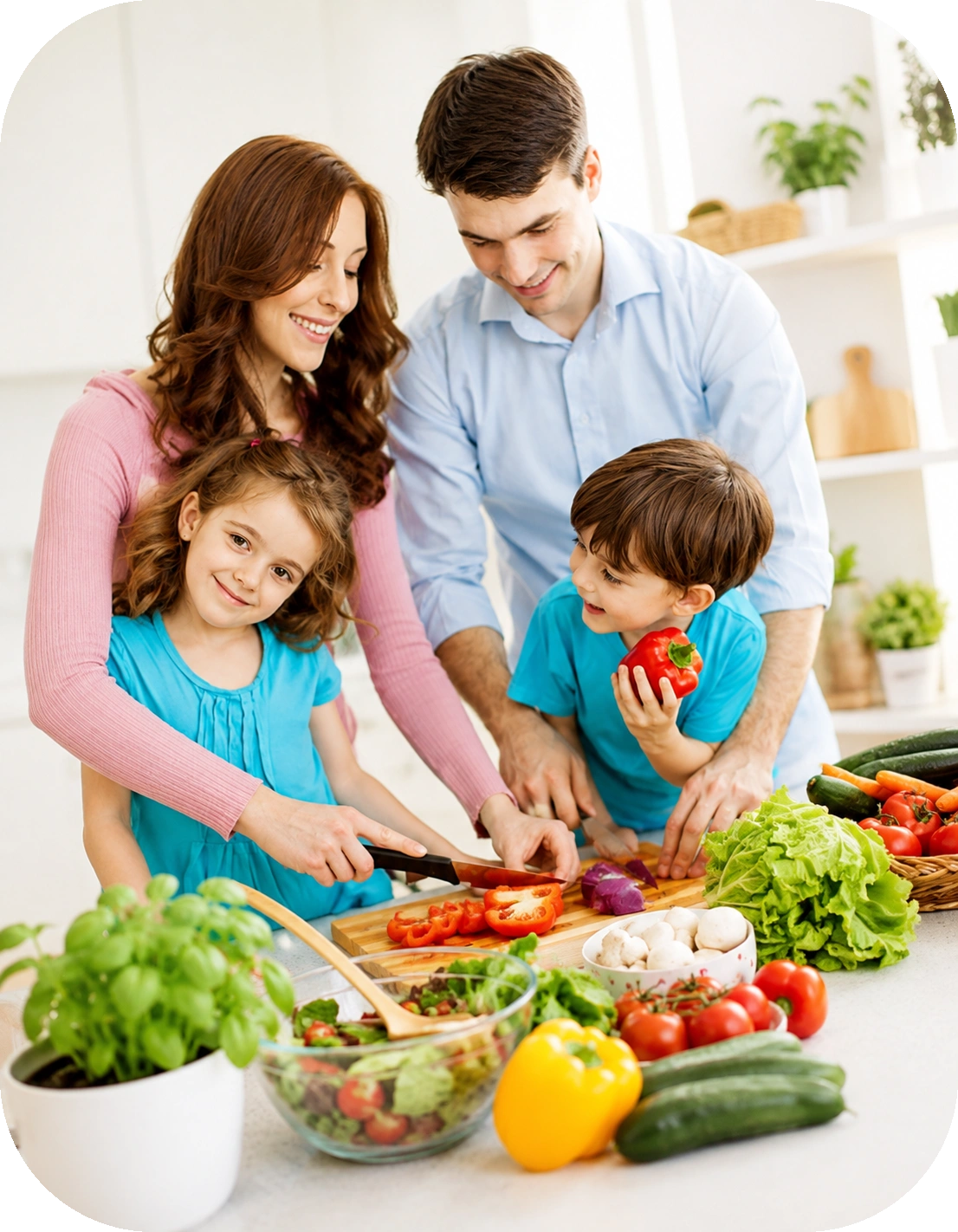 Happy parents cutting fresh bell peppers and vegetables with their young daughter and son at a kitchen counter.